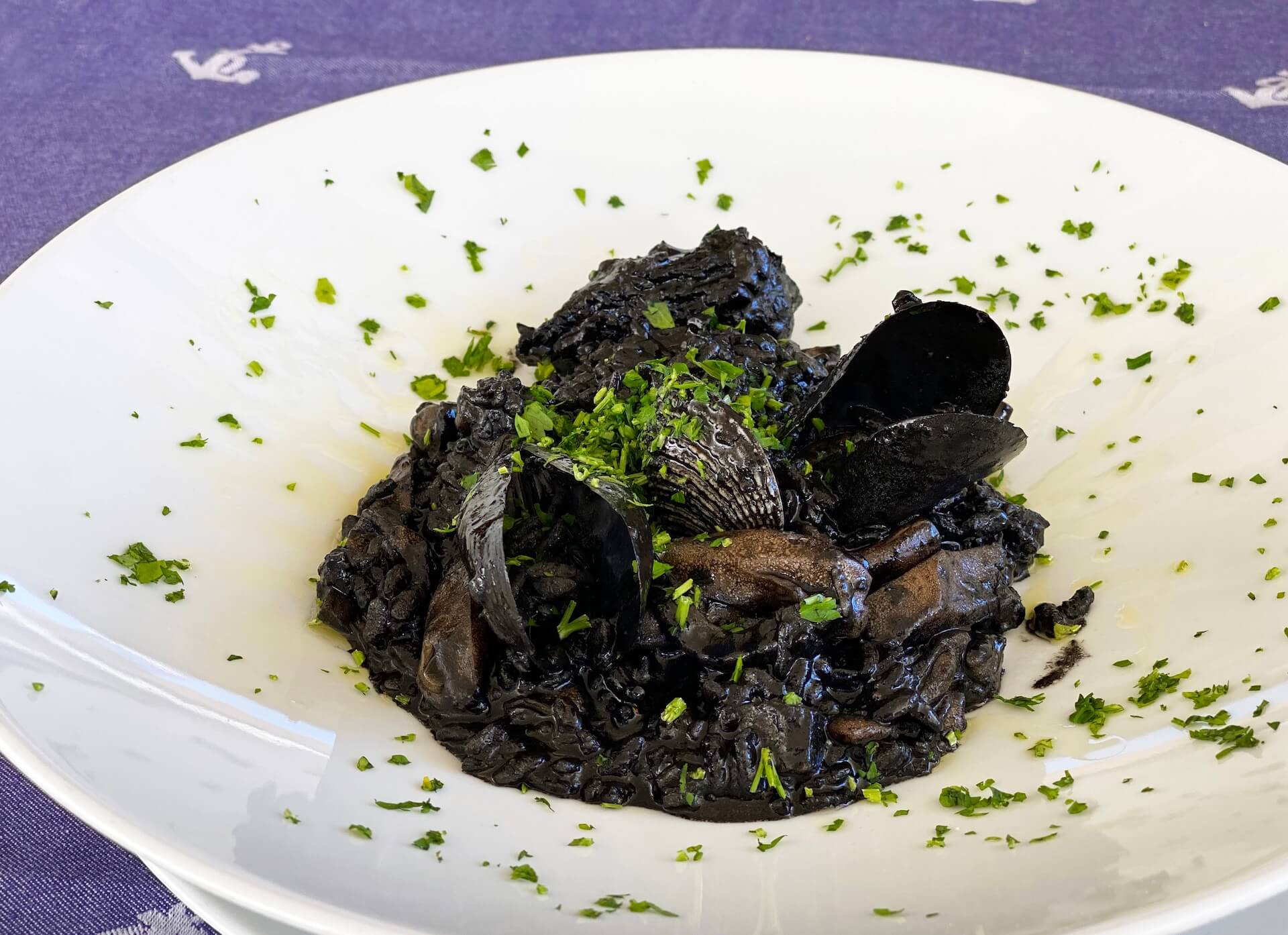 Black cuttlefish-ink risotto with mussels and parsley.