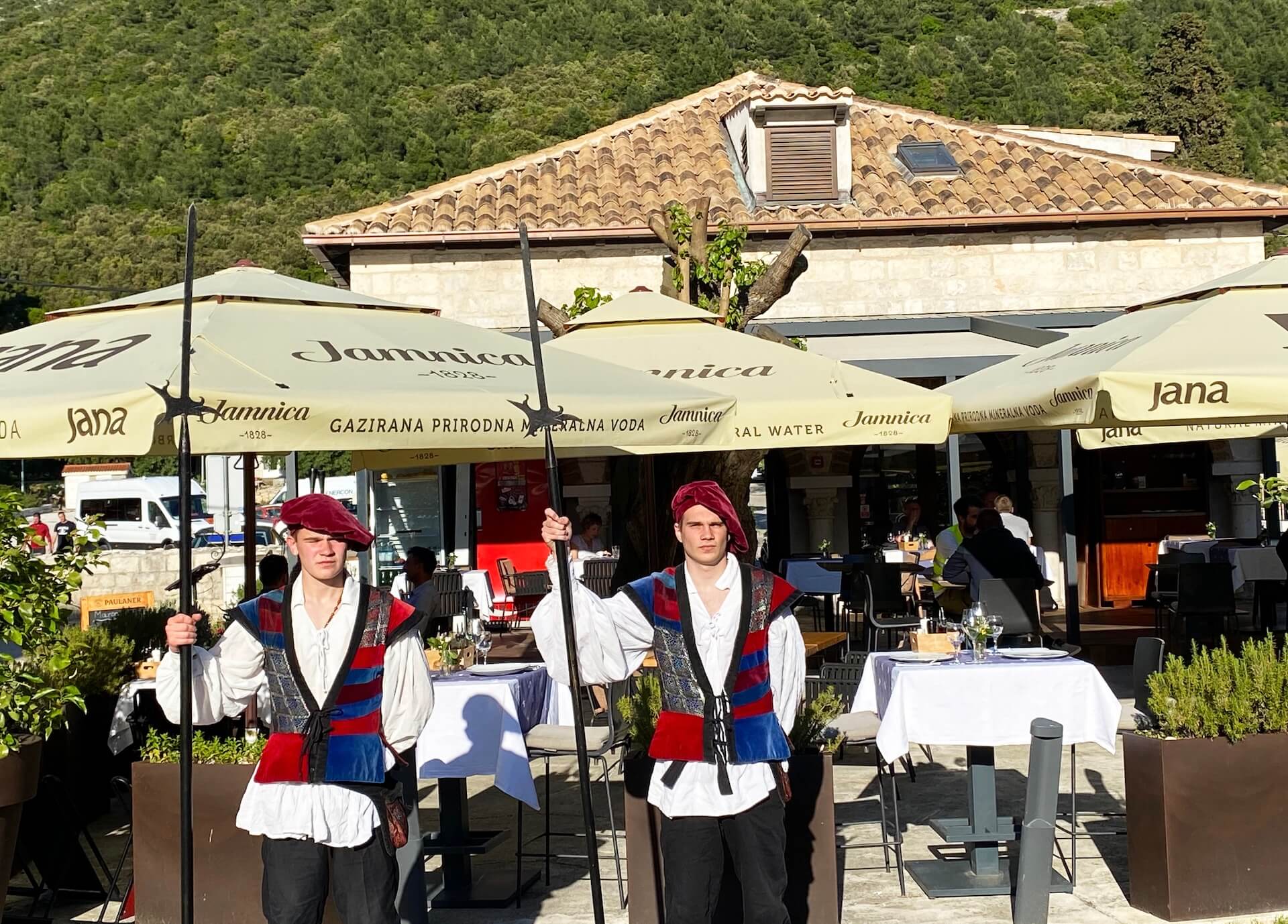 Two of Ston's traditional barbanti city-watch reenactors standing outside the restaurant.