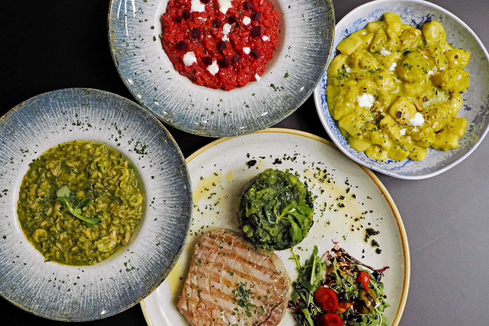 Green and beetroot risottos, gnocchi in a creamy sauce and a grilled tuna steak with Swiss chard.